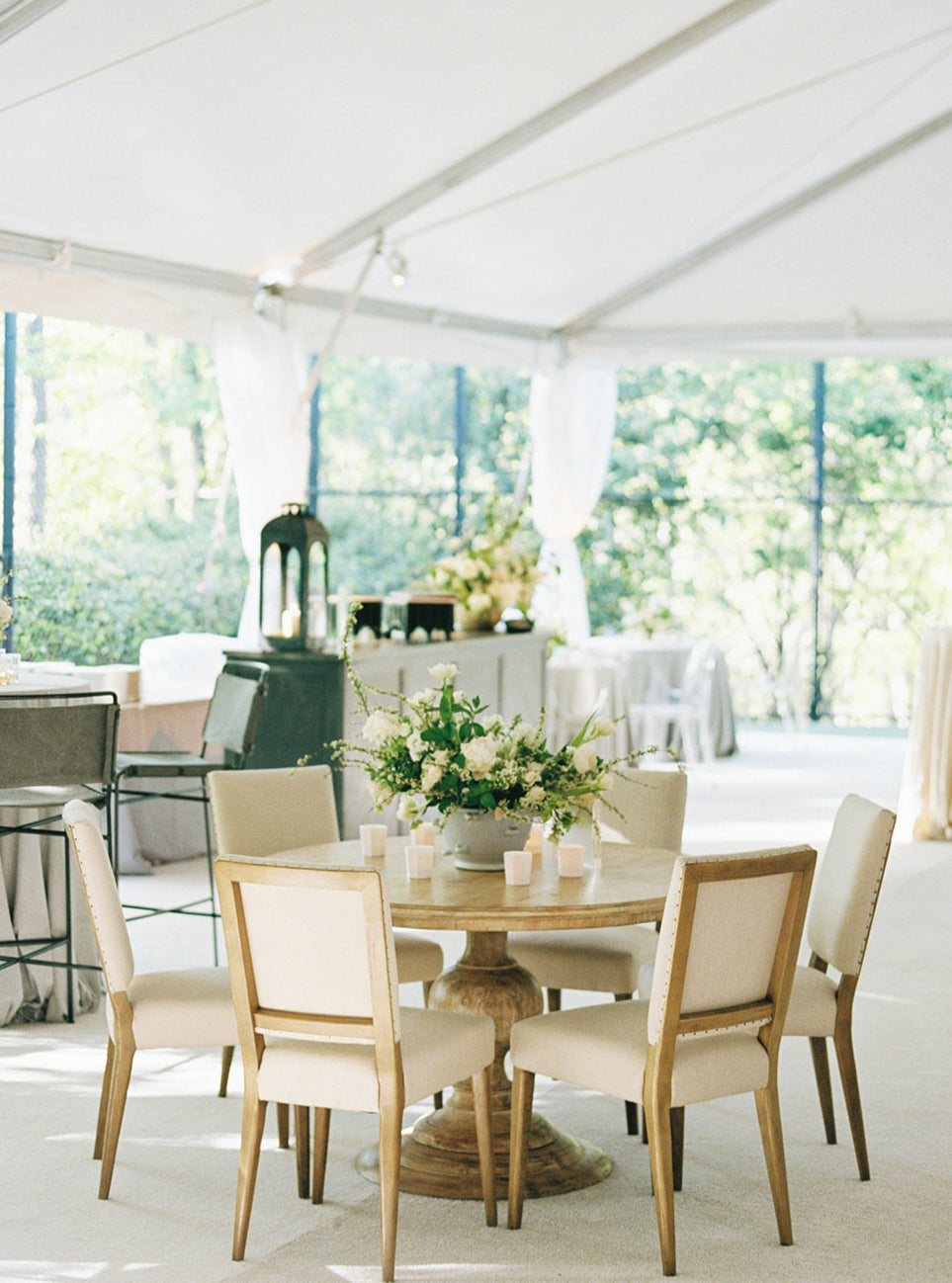 Sunset dinner table under sailcloth tent with Southern-inspired styling