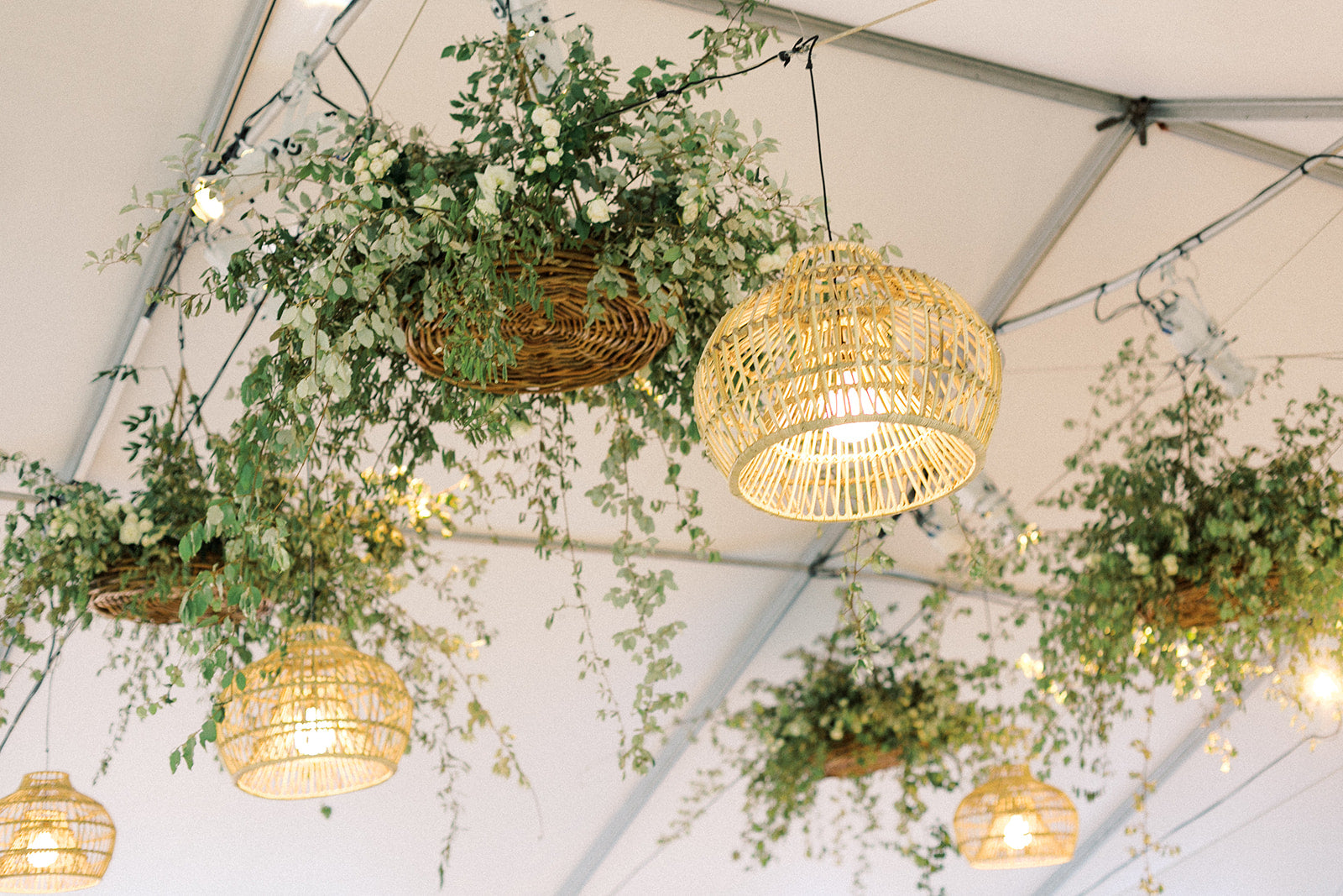 Warm wicker lighting under a sailcloth tent at private event in Milton, GA