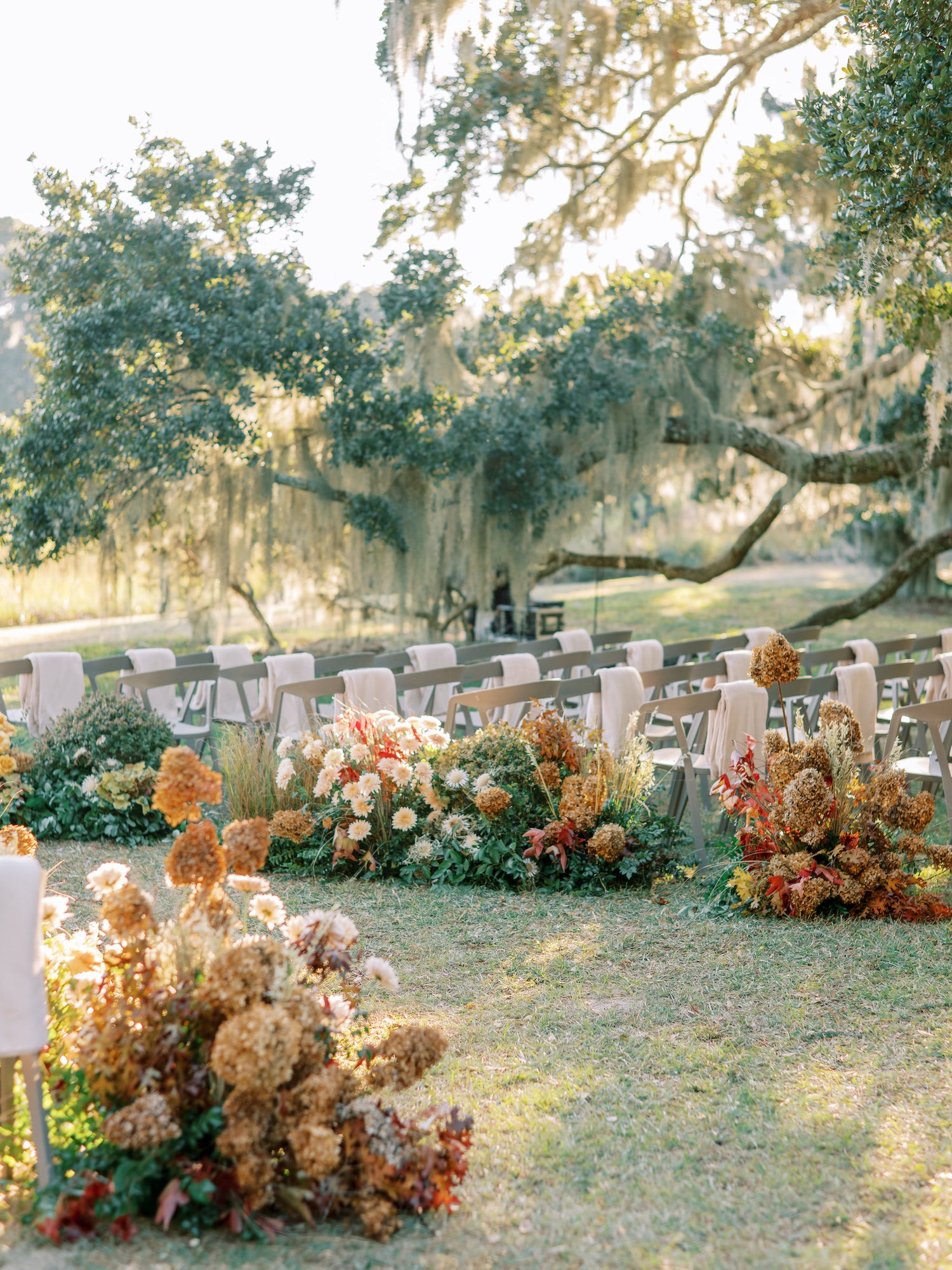 Lowcountry outdoor wedding in South Carolina with organic florals, sculptural seating, and river views.