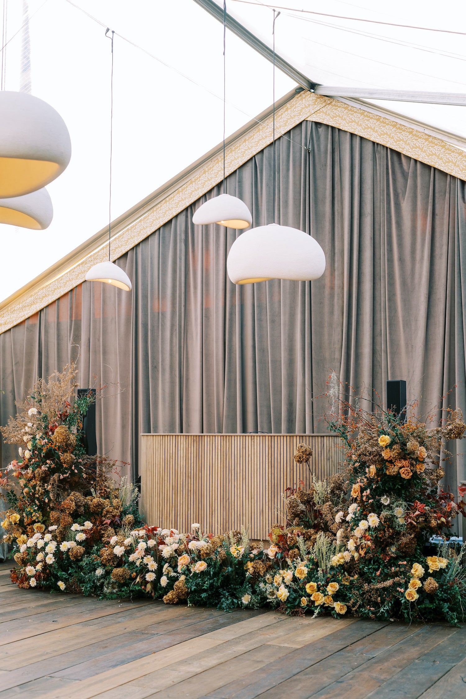 Contemporary wedding bar with sculptural design and soft palette, anchoring the tented reception space
