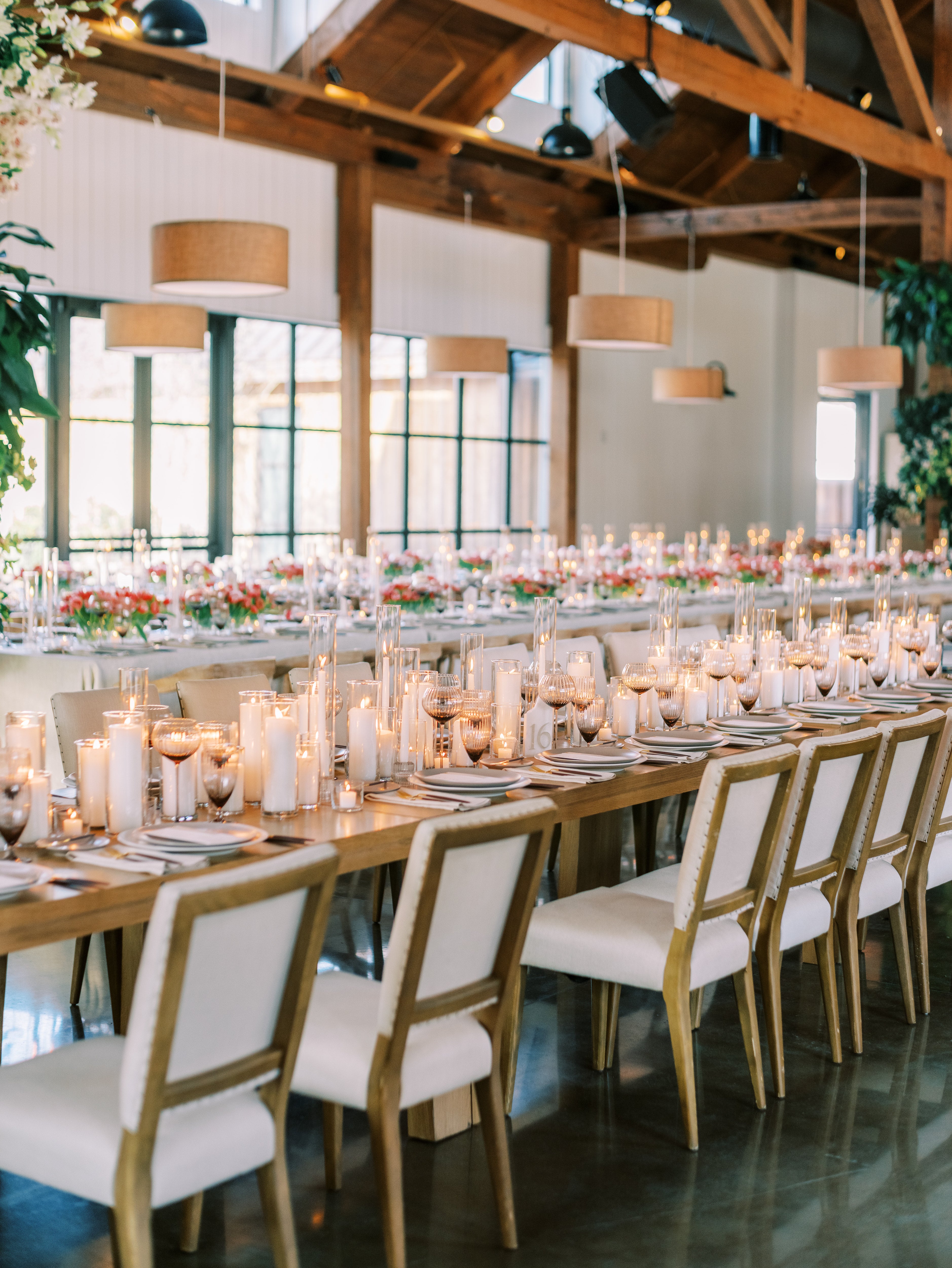 Reception table with with pillar candles and Mayker furniture rentals at Dunlin