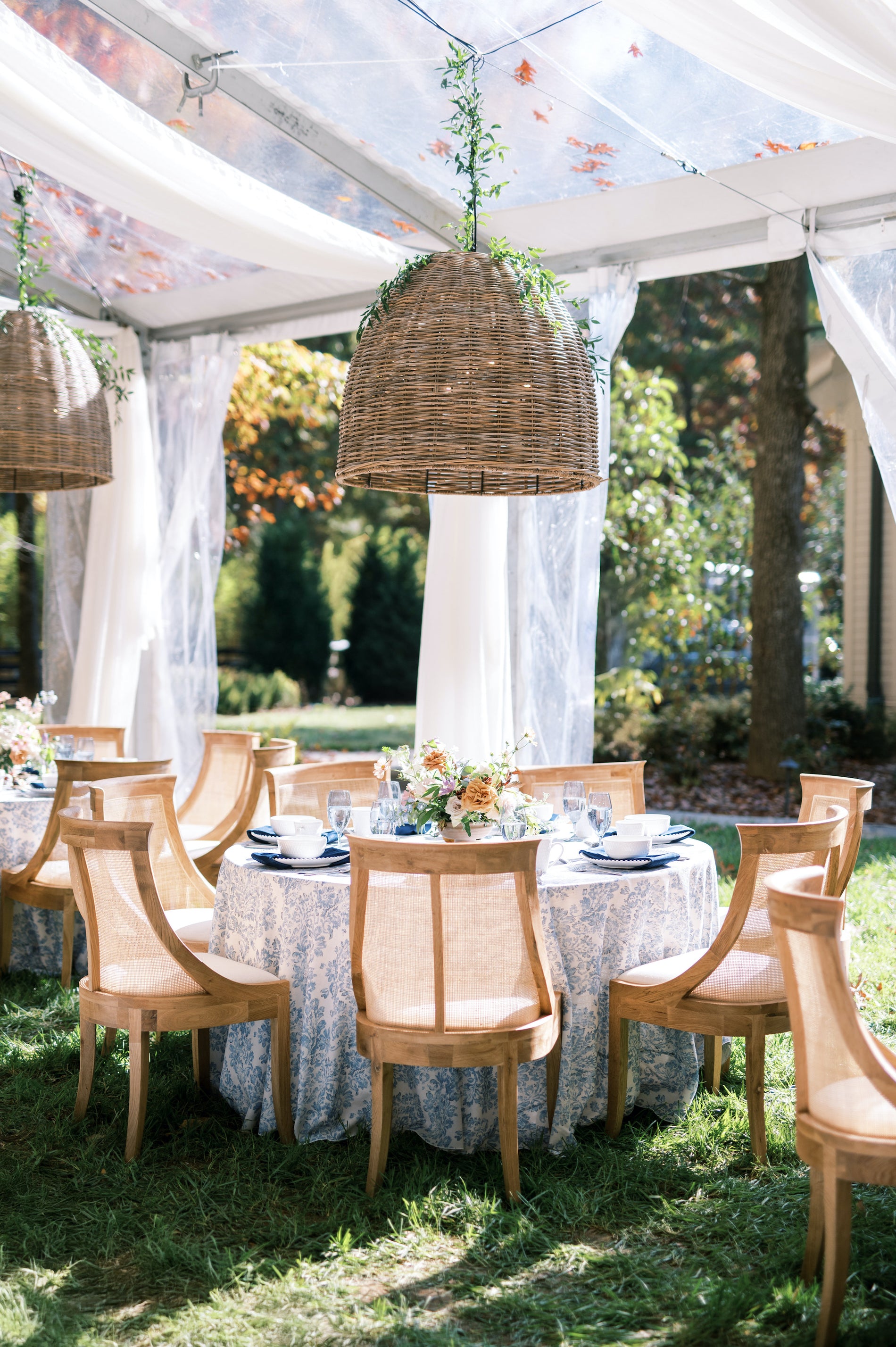 Outdoor dining setup in Lieper's Fork with wooden chairs and a white tablecloth under a clear tent, shot by Kéra Golumbisky